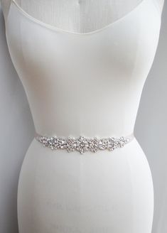 "This elegant bridal belt features crystal and pearl design measuring 8 1/2\" long and 1 5/8 wide at the widest point. Made with French grosgrain ribbon in taupe color measuring 5/8\" wide and 150\" long. Available in gold, rose gold or silver finish and with white or ivory pearl. Also available with double face satin ribbon. - For the photo of the satin ribbon color options please take a look here: https://www.etsy.com/listing/225025505/satin-ribbon-swatches-ribbon-color?ref=shop_home_active_56 Elegant Silver Bridal Accessories For Prom, Elegant Fitted Bridal Accessories With Rhinestones, Silver Bridal Belt With Sashes For Formal Occasion, Silver Rhinestone Bridal Belt For Prom, Elegant Silver Bridal Belt For Prom, Silver Fitted Bridal Belt For Formal Occasions, Elegant Silver Embroidered Belt, Elegant Embellished Fitted Sash, Elegant Embellished Fitted Sashes