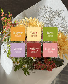 a bunch of flowers that are sitting in a vase with some words on the side