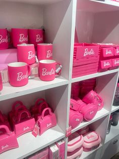 pink bags and purses are on display in a store's shelve