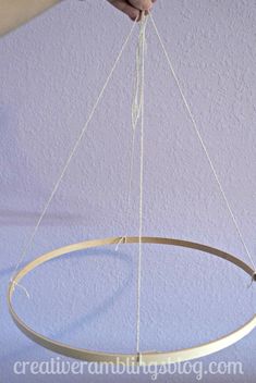 a person is holding an object in the air with two strings hanging from it's sides