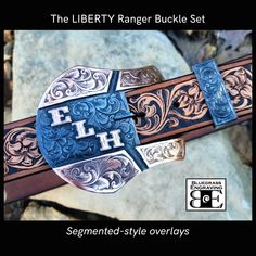 "Treat yourself or a special someone to a custom made ranger buckle set, crafted with care and skill from the best materials by Bluegrass Engraving. Our steel buckles feature overlays that are hand sawn from your choice of metals, and hand engraved in our studio by Brian Ferrand. Unlike many others that are cold-blued, our steel buckles are finished with a hot-blued process for a deep, lustrous finish that also serves to protect the steel. Care instructions are provided with your order. Two-piece handcrafted steel ranger belt buckle set for a 1.5\" width belt: The Liberty shape steel buckle and keeper, overlaid with your choice of metals Segmented-style overlays on the buckle sides Buckle measures approx 3 5/8\" tall x 4\" across Personalized with your ranch brand, initials, Masonic logo, Ranger Belt, Shopping Apps, Custom Belt Buckles, Western Belt Buckles, Gifts For Fiance, Branded Belts, Western Belts, Men Jewelry, Silver Work