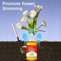 a bottle of flower blooming liquid sitting on top of a pile of dirt with flowers in it