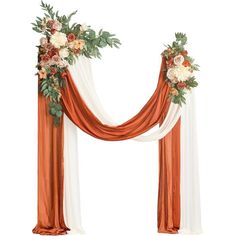 an orange and white wedding arch with flowers on the top, draped in red fabric