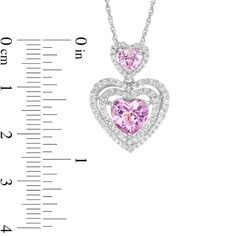 Share the love with this dazzling fashion pendant. Crafted in sterling silver, this clever design pairs heart-shaped lab-created pink sapphires with ribbons of shimmering round lab-created white sapphires in a unique double drop design. Perfect for that special evening out, this eye-catching pendant suspends along an 18.0-inch box chain that secures with a spring-ring clasp. Pink Heart Pendant Jewelry With Diamond Accents, Pink Heart Cut Sparkling Stones Jewelry, Pink Open Heart Jewelry For Anniversary, Pink Heart Pendant Jewelry For Anniversary Gift, Pink Jewelry For Anniversary On Valentine's Day, Heart-shaped Pink Jewelry For Anniversary Gift, Pink Heart-shaped Jewelry With Accent Stones, Fashion Pendant, Drop Design