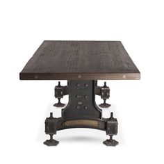 an old fashioned wooden table with metal accents on the legs and feet, against a white background