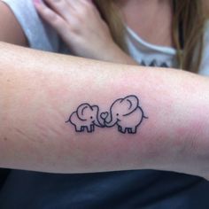 a woman's arm with an elephant tattoo on it