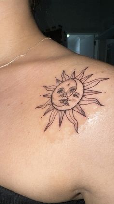 a woman with a sun tattoo on her chest