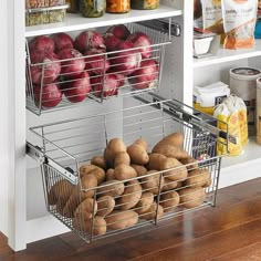 an organized pantry with apples, potatoes and other food in baskets on the bottom shelf