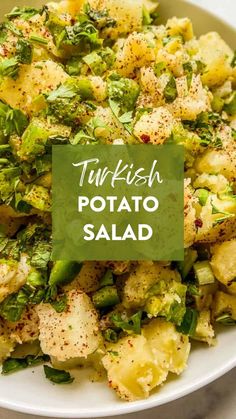 a white bowl filled with potatoes and broccoli next to a green sign that says tur - fish potato salad