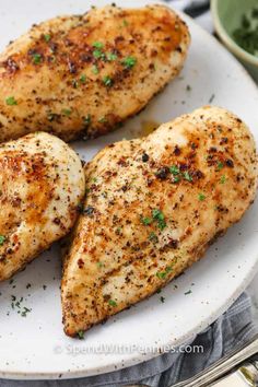 three pieces of chicken on a white plate