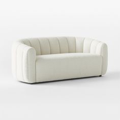 a white couch sitting on top of a white floor