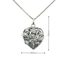 Transport yourself back to a more romantic era with this enchanting heart-shaped locket. With its delicate floral pattern and vintage style, this locket is an endearing way to keep special memories close to your heart. The intricate cut-out design on the front reveals the precious photo kept safe within. So whether you're celebrating a special occasion or simply looking for a timeless piece of jewelry to treasure, this locket makes a sweet and sentimental gift for yourself or a loved one. Materi Double Heart Locket Necklace For Wedding, Wedding Double Heart Locket Necklace, Delicate Heart Pendant Locket Necklace, Heart Pendant Locket Necklace With Vintage Charm For Wedding, Heart Pendant Locket Necklace For Wedding, Wedding Heart Medallion Locket Necklace, Elegant Heart Locket Necklace As Gift For Her, Wedding Open Heart Locket Necklace, Elegant Heart Locket Necklace For Mother's Day