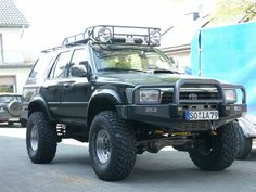 a large black truck parked in front of a house