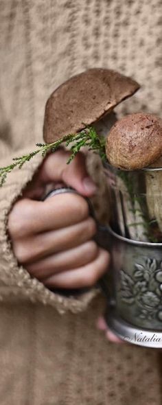 a person holding a metal bowl with food in it