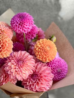 a bouquet of pink and orange flowers in a vase