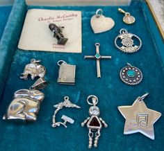 "Adorable vintage sterling silver charms 1) Charlie McCarthy Movable sterling charm-comes on original paper 2)Sterling heart 3)Inlaid turquoise cross 4)\"Great Adventure\" ferris wheel charm sterling 5)Opening book charm silver-doesn't stay closed 6)Sterling rabbit charm or pendant 7)Silver elephant 8)Silver and gold religious mary circle charm 9)Circle turquoise sterling charm 10)Music not star sterling charm 11)Movable red stone girl charm 12)\"Aruba\" tree sterling charm SOLD Separate -Some h Collectible Nickel-free Sterling Silver Charms, Antique Sterling Silver Charms, Nickel Free, Antique Sterling Silver Nickel-free Charms, Antique Nickel-free Sterling Silver Charms, Vintage Sterling Silver Charms For Gifts, Vintage Sterling Silver Charm Necklaces For Jewelry Making, Antique Sterling Silver Charms For Collectible, Antique Sterling Silver Charms For Collectors, Vintage Sterling Silver Charm Necklaces For Anniversary