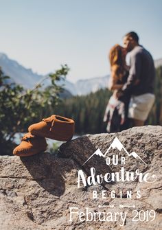 a couple standing on top of a rock next to each other