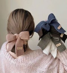 a woman with her back to the camera wearing a knitted sweater and bow tie