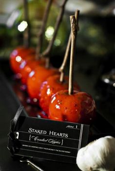 tomatoes and garlic are arranged in rows on a table with a name tag that says staked hearts