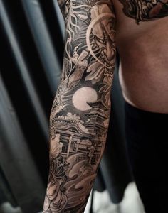 a man's arm with tattoos on it