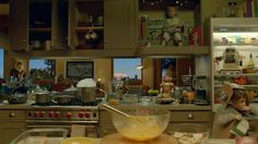 a kitchen filled with lots of clutter and cooking utensils on the counter