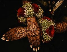 the hands and feet of a woman decorated with flowers