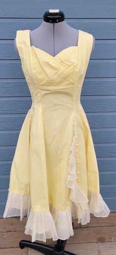 1950s handmade yellow a-line dress with ruffle down the front and on the skirt bottom. It has a shelf bra and metal zipper.  No size and no company Measurements Length 40.5 inches chest 36 inches waist  26 inches Yellow Dresses With Ruffles And Fitted Bodice, Yellow Fitted Dress In 1950s Style, Fitted Yellow Dress In 1950s Style, Yellow Vintage Dress For Vintage Events, Yellow Vintage Dress 1950s Style For Spring, Yellow Vintage Dress, 1950s Style For Spring, Yellow 1950s Style Dress For Vintage Fashion, Fitted Yellow Vintage Dress For Party, Yellow Fitted Vintage Dress For Parties