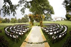 an outdoor ceremony setup with rows of chairs