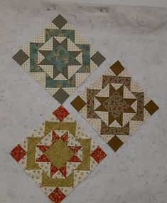 three quilted squares with different designs on them