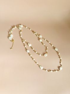 Introducing our most dreamy bridal necklace! A delicate gold chain adorned with freshwater baroque pearls and cubic zirconia forms a boho-inspired lariat necklace. Wear it in the front or back, and a backdrop option is also available if needed. **Custom necklace available** 🖤 M A T E R I A L S  *  A N D  *  S I Z E  🖤 ❇️ MATERIAL & METAL: Brass- Freshwater Pearl/Cubic Zirconia ❇️ METAL PLATING: Gold ❇️ ESTIMATED NECKLACE SIZE: (1st layer) 26.5-inch (2nd layer) 20-inch + 2-inch Extension ❇️ ESTIMATED BACKDROP SIZE: 11.5-inch ❇️ QUANTITY: 1pcs/1pairs ❇️ LEAD-FREE & NICKEL FREE 🖤 A V A I L A B L E  *  F I N I S H 🖤 ❇️NECKLACE ❇️NECKLACE & BACKDROP  🖤 C U S T O M I Z I N G  *  A N  *  E X I S T I N G  *  P I E C E 🖤 If you love this piece but feel you would like to make a few changes or White Pearl Chain Necklace With Pearl Drop, Feminine Single Strand Pearl White Jewelry, Feminine Pearl White Single Strand Jewelry, Elegant Necklace With Baroque Pearl And Delicate Chain, Long Beaded Necklace With Pearl Charm, Pearl White Long Pearl Chain Necklace, Pearl White Long Single Strand Necklace, Elegant Baroque Pearl Necklace With Delicate Chain, Dainty Long Chain Necklace For Wedding