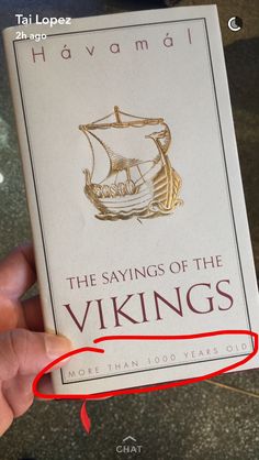 a hand holding up a book with the title'the sayings of the vikings '