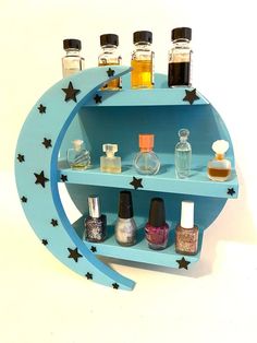 a blue shelf with bottles on it and stars around the shelves, along with nail polish