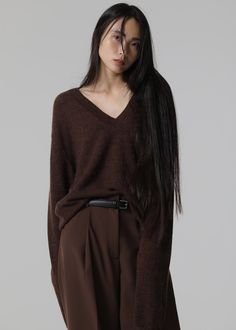 Color: Brown Lightweight wool blend fabric Regular fit Deep v neck Drop shoulders Rib knit trim Slip on style Unlined 35% Polyamide 30% Wool 25% Alpaca 10% Acrylic Dry Clean Imported