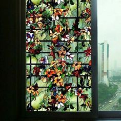 a stained glass window in the corner of a room with a view of a city