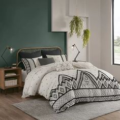 a bedroom with green walls and white bedding