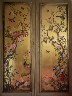 two painted doors with birds and flowers on the outside, one is gold in color