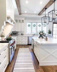 the kitchen is clean and ready to be used for cooking or baking, with white cabinets and wood flooring