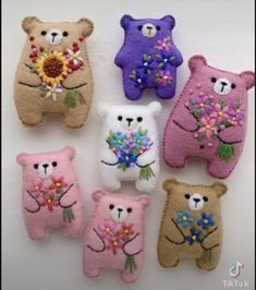 four teddy bears are decorated with flowers and daisies in different colors, sizes and shapes