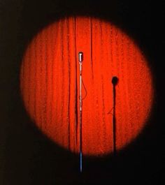 a microphone is shown in the middle of a dark room