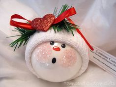 a snowman ornament with a red bow on it's head and the words 11 get a child's glove to make the hat of a baby snowman