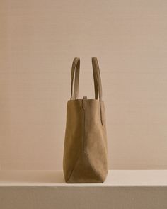 The Eleanor Tote is the perfect slouchy, easy tote bag. Crafted from the softest Calfskin suede in Mushroom with tonal stitching, the Eleanor Tote features a third strap which fastens using our signature collar studs.