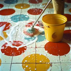 a person is using a brush to paint the floor