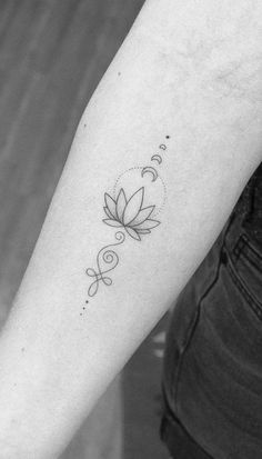 a woman's arm with a flower tattoo on the left side of her arm