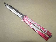 a pink and white knife with the word love on it