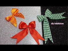 three bows with polka dots on them sitting next to each other in front of a glitter background