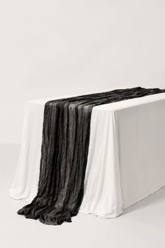 a white table topped with black and white cloth