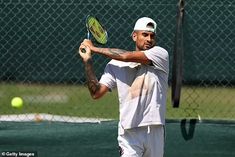 a man holding a tennis racquet on top of a tennis court with a ball in the air