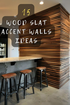 the interior of a restaurant with wooden slats on the wall and stools at the bar