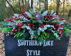 a wooden sign that says southern edge style with evergreens and red berries in it