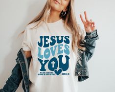 Jesus Loves You Tees, Jesus T-Shirt, Christian Shirt, Aesthetic Clothes, Bible Verse Shirt, Jesus Tees, Christian Merch, Gift For Her, New. Unisex Sizing Across All Products Discover your perfect fit with our size and color guides, available in the product photo gallery.  How to Order from Our Etsy Store Excited about our offerings? Follow these easy steps to make them yours: 1) Explore: Dive into our curated collection and find products that resonate with your style. Our attention to detail shines through in every piece. 2) Select: Found something you love? Click on it for more details like size, color, and personalization options. 3)Customize: Pick your preferences from the dropdown menus. For personal touches, use the provided text box for your specifications. 4)Add to Cart: Once you're Christian Merch, We Love Each Other, Jesus Tees, Bible Verse Shirt, Shirt Aesthetic, Jesus Tshirts, Christian Shirt, Jesus Shirts, Jesus Loves You